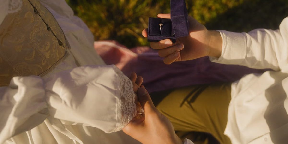 Vintage-inspired outdoor proposal with engagement ring and romantic atmosphere.
