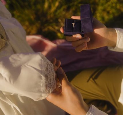 Vintage-inspired outdoor proposal with engagement ring and romantic atmosphere.