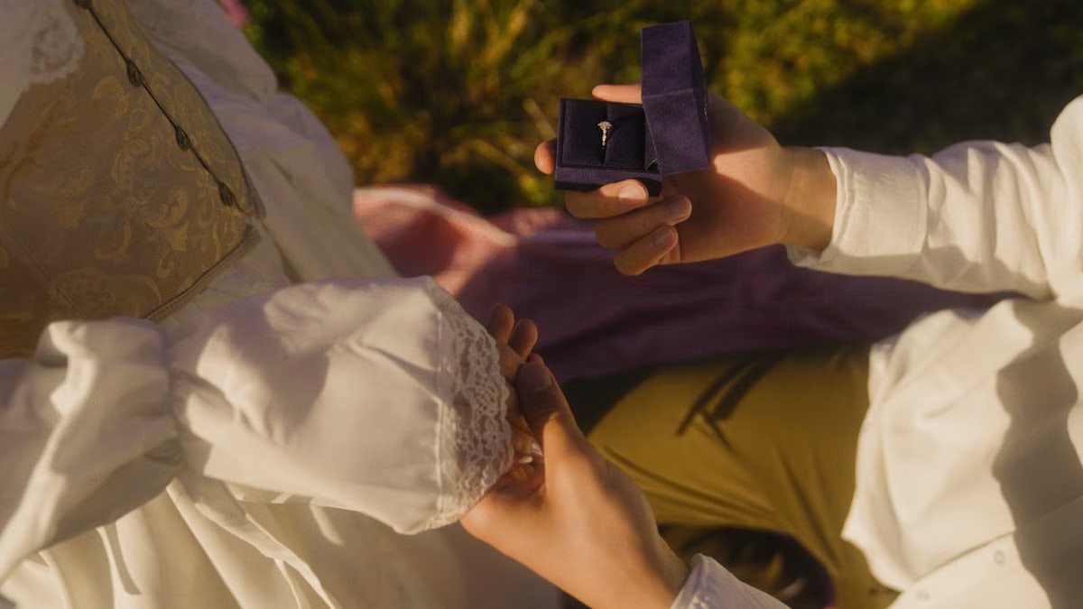 Vintage-inspired outdoor proposal with engagement ring and romantic atmosphere.